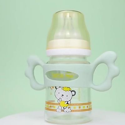 Biberon avec poignée silicone vert facile à tenir